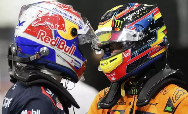 Red Bull driver Max Verstappen of the Netherlands, pole position, left, cheers with McLaren driver Oscar Piastri of Australia, second fastest time, after the qualifying session ahead of the Formula One Saudi Arabian Grand Prix at the Jeddah Corniche Circuit in Jeddah, Saudi Arabia, Saturday, April 19, 2025. (AP Photo/Darko Bandic)