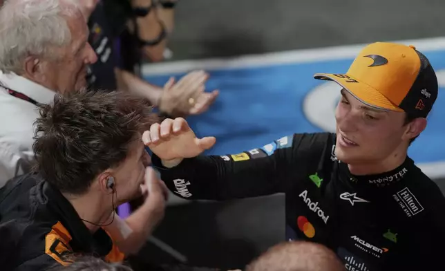 McLaren driver Oscar Piastri of Australia, right, celebrates with his team after winning the Formula One Saudi Arabian Grand Prix at the Jeddah Corniche Circuit in Jeddah, Saudi Arabia, Sunday, April 20, 2025. (AP Photo/Darko Bandic)