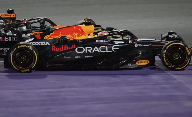 Red Bull driver Max Verstappen of the Netherlands, front, steers his car followed by McLaren driver Oscar Piastri of Australia during the Formula One Saudi Arabian Grand Prix at the Jeddah Corniche Circuit in Jeddah, Saudi Arabia, Sunday, April 20, 2025. (AP Photo/Darko Bandic)