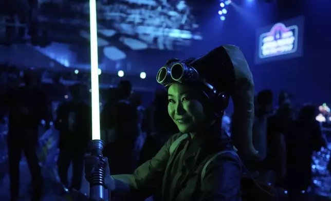 A Star Wars supporter poses for a photo during a fan convention called the Star Wars Celebration Japan in Chiba, near Tokyo, Friday, April 18, 2025. (AP Photo/Hiro Komae)