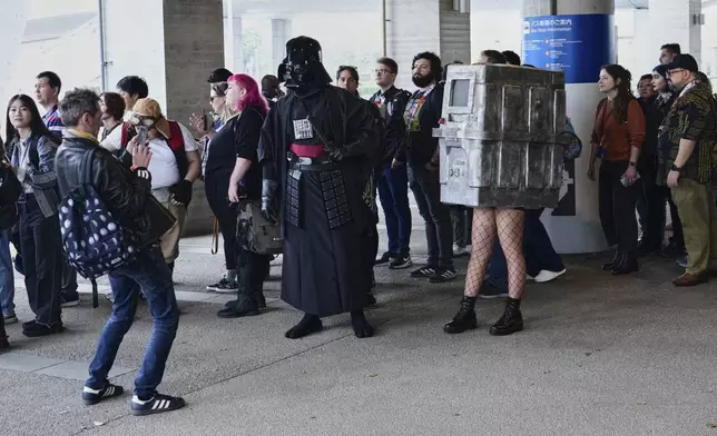 People line up to enter the Makuhari Messe convention center for the Star Wars Celebration Japan in Chiba, near Tokyo, Friday, April 18, 2025. (AP Photo/Hiro Komae)