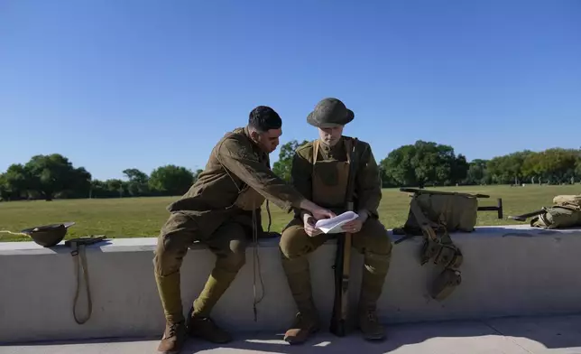 Members of the Army military, Joe Galli, left, and Michael Doblosky, right, prepare for a ceremony at Fort Benning, honoring new namesake on Wednesday, April 16, 2025, in Fort Benning, Ga. (AP Photo/Brynn Anderson)