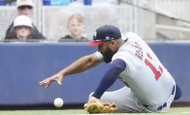 Washington Nationals second baseman Amed Rosario (13) fields a ball hit by Miami Marlins' Kyle Stowers for a single during the seventh inning of a baseball game, Sunday, April 13, 2025, in Miami. (AP Photo/Lynne Sladky)