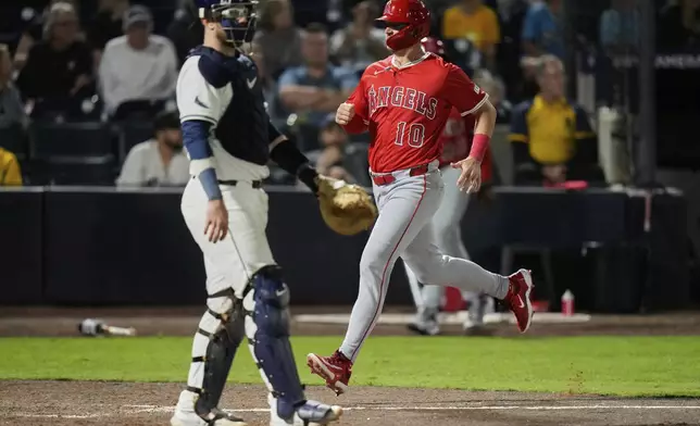Los Angeles Angels' Kevin Newman (10) scores behind Tampa Bay Rays catcher Danny Jansen on an RBI single by Luis Rengifo during the ninth inning of a baseball game Tuesday, April 8, 2025, in Tampa, Fla. (AP Photo/Chris O'Meara)