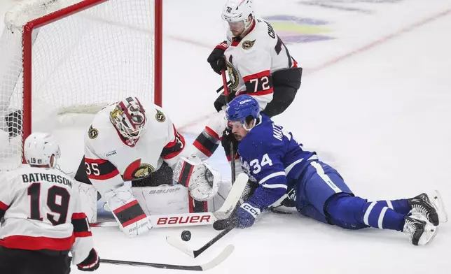 Toronto Maple Leafs' Auston Matthews (34) tries to make a shot on Ottawa Senators goaltender Linus Ullmark (35) with pressure from Ottawa Senators' Thomas Chabot (72) during third period NHL playoff action in Toronto on Tuesday, April 22, 2025. (Nick Iwanyshyn/The Canadian Press via AP)