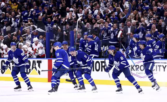The Toronto Maple Leafs celebrate the overtime win during NHL playoff action in Toronto, on Tuesday, April 22, 2025. (Cole Burston/The Canadian Press via AP)