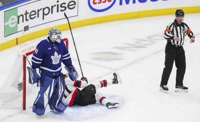 Toronto Maple Leafs goaltender Anthony Stolarz (41) looks toward the referee after receiving an interference penalty against Ottawa Senators' Ridly Greig (71) during second period NHL playoff action in Toronto on Tuesday, April 22, 2025. (Cole Burston/The Canadian Press via AP)