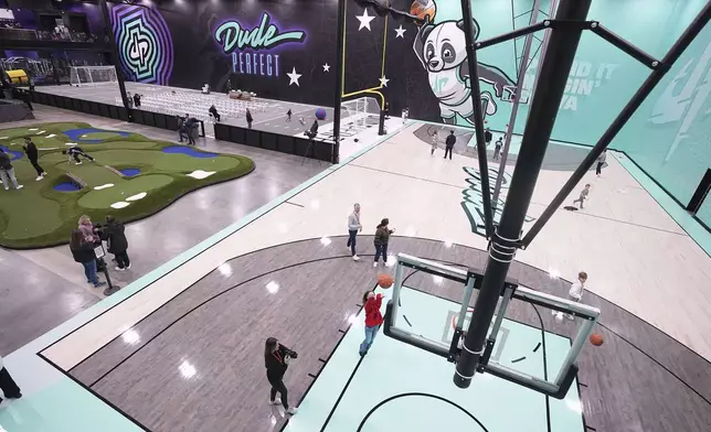 Visitors attending an event enjoy some of the attractions at Dude Perfect's new headquarters in Frisco, Texas, Wednesday, Feb. 19, 2025. (AP Photo/Tony Gutierrez)
