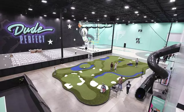 Visitors attending an event enjoy some of the attractions at Dude Perfect's new headquarters in Frisco, Texas, Wednesday, Feb. 19, 2025. (AP Photo/Tony Gutierrez)