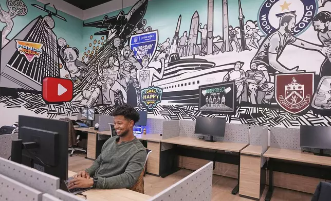 Employee Justus Woods works in an office at Dude Perfect's new headquarters in Frisco, Texas, Wednesday, Feb. 19, 2025. (AP Photo/Tony Gutierrez)