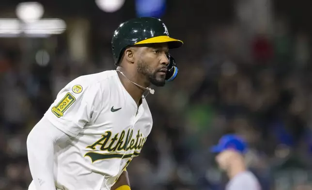 Athletics' Miguel Andujar (22) runs the bases after hitting an RBI home run during the sixth inning of a baseball game against the New York Mets, Friday, April 11, 2025, in West Sacramento, Calif. (AP Photo/Sara Nevis)