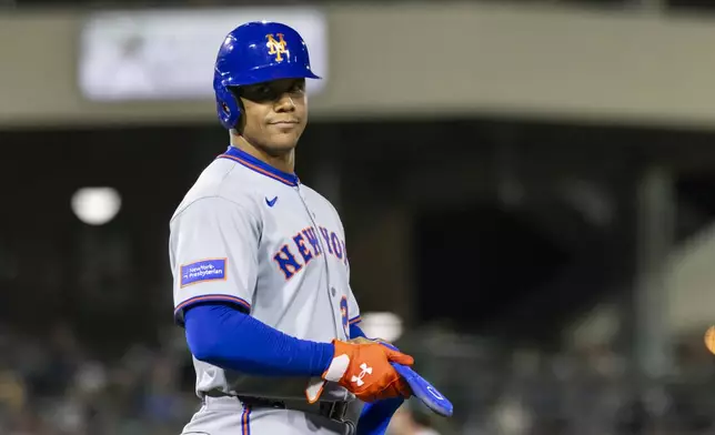 New York Mets' Juan Soto (22) looks to the dugout after being walked during the sixth inning of a baseball game against the Athletics, Friday, April 11, 2025, in West Sacramento, Calif. (AP Photo/Sara Nevis)