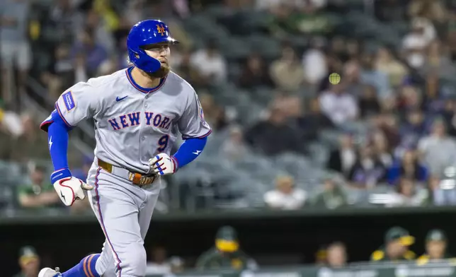 New York Mets' Brandon Nimmo (9) runs to first base after being walked during the sixth inning of a baseball game against the Athletics, Friday, April 11, 2025, in West Sacramento, Calif. (AP Photo/Sara Nevis)
