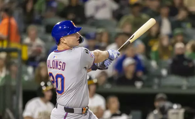 New York Mets' Pete Alonso (20) hits an RBI double during the fifth inning of a baseball game against the Athletics, Friday, April 11, 2025, in West Sacramento, Calif. (AP Photo/Sara Nevis)