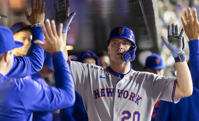 New York Mets' Pete Alonso (20) celebrates in the dugout after hitting a solo home run during the eighth inning of a baseball game against the Athletics, Friday, April 11, 2025, in West Sacramento, Calif. (AP Photo/Sara Nevis)
