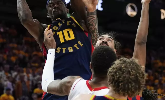 Golden State Warriors forward Jimmy Butler III (10) rebounds the ball next to Houston Rockets center Steven Adams, rear, during the second half of Game 4 of an NBA basketball first-round playoff series Monday, April 28, 2025, in San Francisco. (AP Photo/Godofredo A. Vásquez)