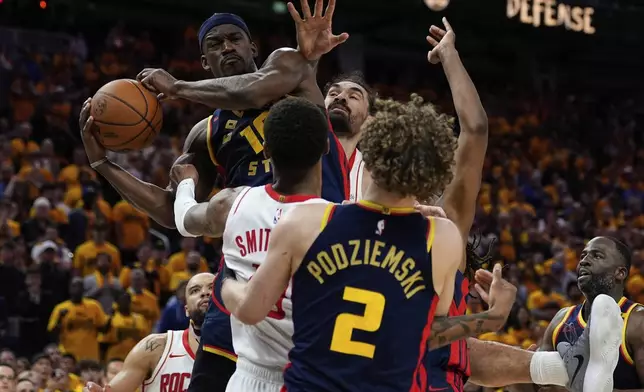 Golden State Warriors forward Jimmy Butler III (10) rebounds the ball next to Houston Rockets center Steven Adams, rear, during the second half of Game 4 of an NBA basketball first-round playoff series Monday, April 28, 2025, in San Francisco. (AP Photo/Godofredo A. Vásquez)