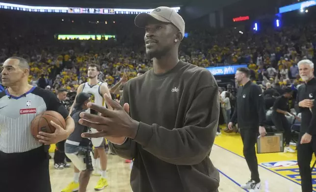 Injured Golden State Warriors forward Jimmy Butler III walks on the floor after Game 3 of an NBA basketball first-round playoff series against the Houston Rockets in San Francisco, Saturday, April 26, 2025. (AP Photo/Jeff Chiu)