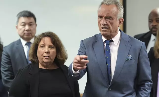 U.S. Health Secretary Robert F. Kennedy Jr., right, is accompanied by Susan Levy, Native Health Communications and Community Relations director, during a tour of the Native Health Mesa Food Distribution Center, in Mesa, Ariz., Tuesday, April 8, 2025. (AP Photo/Ross D. Franklin)