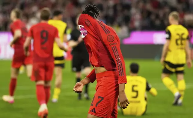 Bayern's Michael Olise reacts after the German Bundesliga soccer match between Bayern Munich and Borussia Dortmund at the Allianz Arena in Munich, Germany, Saturday, April 12, 2025. (AP Photo/Matthias Schrader)