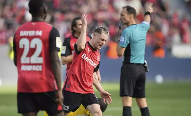 Leverkusen's Florian Wirtz, centre, reacts during the German Bundesliga soccer match between Bayer Leverkusen and Union Berlin at the BayArena in Leverkusen, Germany, Saturday, April 12, 2025. (AP Photo/Martin Meissner)