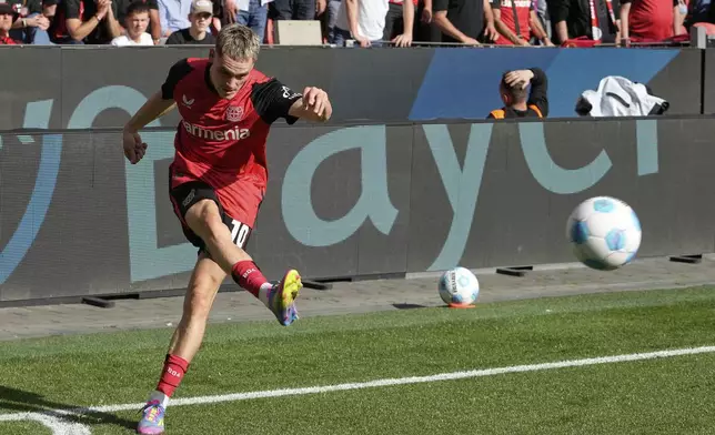 Leverkusen's Florian Wirtz kicks the ball during the German Bundesliga soccer match between Bayer Leverkusen and Union Berlin at the BayArena in Leverkusen, Germany, Saturday, April 12, 2025. (AP Photo/Martin Meissner)