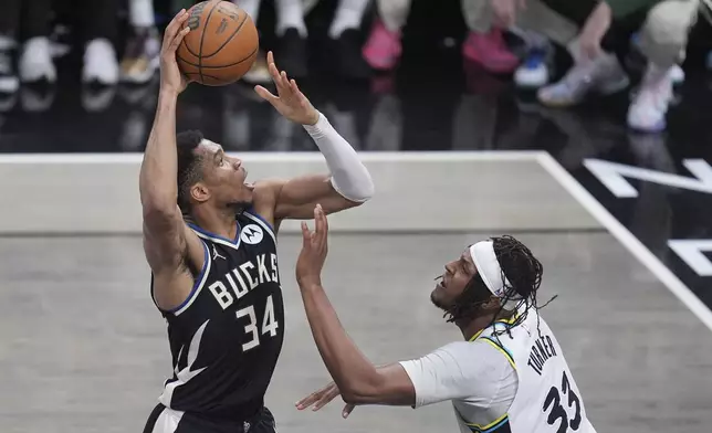 Milwaukee Bucks forward Giannis Antetokounmpo (34) shoots the ball over Indiana Pacers center Myles Turner (33) during the second half in Game 5 of an NBA basketball first-round playoff series in Indianapolis, Tuesday, April 29, 2025. (AP Photo/Michael Conroy)