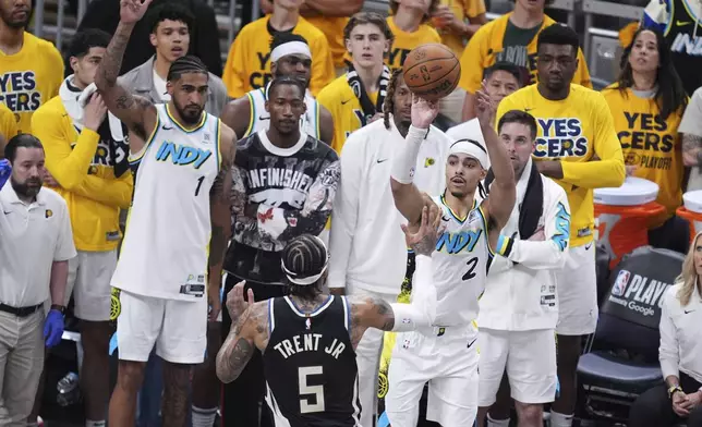 Indiana Pacers guard Andrew Nembhard (2) shoots the ball over Milwaukee Bucks guard Gary Trent Jr. (5) during the second half in Game 5 of an NBA basketball first-round playoff series in Indianapolis, Tuesday, April 29, 2025. (AP Photo/Michael Conroy)