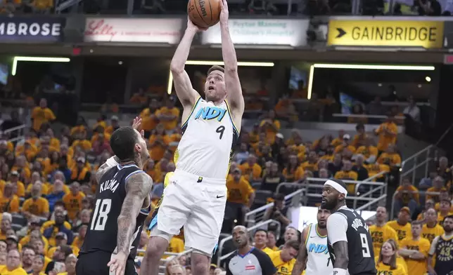 Indiana Pacers guard T.J. McConnell (9) shoots the ball over Milwaukee Bucks forward Kyle Kuzma (18) during the second half in Game 5 of an NBA basketball first-round playoff series in Indianapolis, Tuesday, April 29, 2025. (AP Photo/Michael Conroy)
