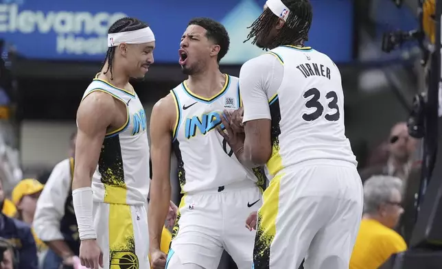 Indiana Pacers guard Tyrese Haliburton, center, celebrates a defensive play with teammates Andrew Nembhard, left, and center Myles Turner (33) during the second half in Game 5 of an NBA basketball first-round playoff series against the Indiana Pacers, in Indianapolis, Tuesday, April 29, 2025. (AP Photo/Michael Conroy)