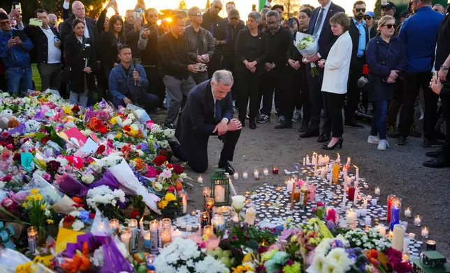 Liberal Leader Mark Carney takes a moment after lighting a candle at a memorial for victims after a vehicle drove into a crowd during a Filipino heritage festival in Vancouver, British Columbia, Sunday, April 27, 2025. (Sean Kilpatrick/The Canadian Press via AP)
