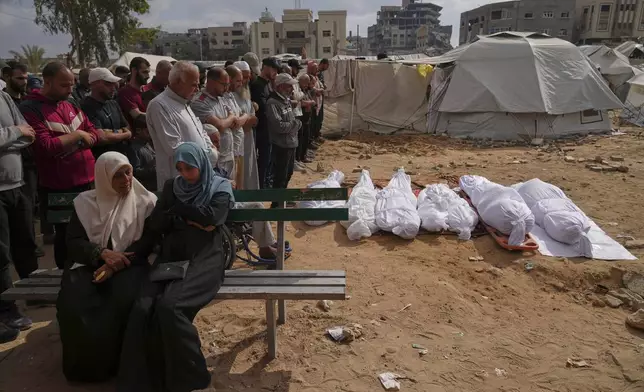 Relatives mourn over the bodies of several members of the Abu Mahdi family, killed in an Israeli army airstrike, during their funeral at the Indonesian hospital in Beit Lahia, northern Gaza Strip, Monday, April 28, 2025. (AP Photo Jehad Alshrafi)