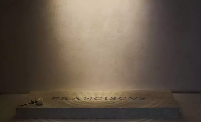 A white rose is placed on the tomb of Pope Francis inside St. Mary Major Basilica in Rome, Monday, April 28, 2025. (AP Photo/Bernat Armangue)