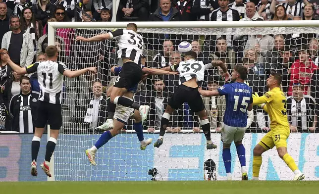 Newcastle United's Dan Burn, 33, scores during the English Premier League soccer match between Newcastle United and Ipswich Town at St James' Park, Newcastle, England, Saturday April 26, 2025. (Owen Humphreys/PA via AP)