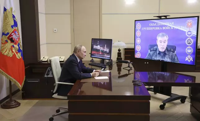 Russian President Vladimir Putin listens to Russian Chief of General Staff Gen. Valery Gerasimov with the report that all Ukrainian troops have been forced from Russia's Kursk region, during their meeting via videoconference at the Novo-Ogaryovo residence outside Moscow, Russia, Saturday, April 26, 2025. (Alexander Kazakov, Sputnik, Kremlin Pool Photo via AP)