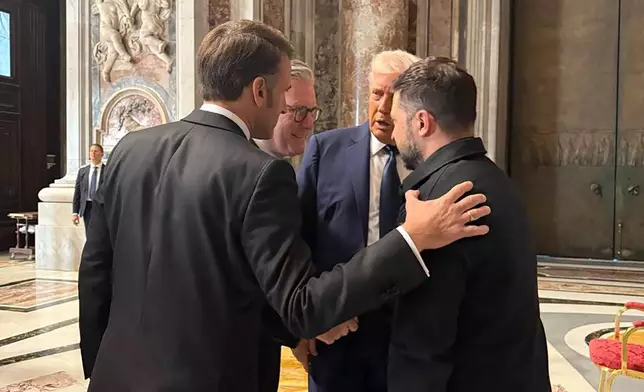 In this photo provided by the Ukrainian Presidential Press Office, Ukraine's President Volodymyr Zelenskyy, right, President Donald Trump, second right, French President Emmanuel Macron, left, and British Prime Minister Keir Starmer talk as they attend the funeral of Pope Francis in Vatican, Saturday, April 26, 2025.(Ukrainian Presidential Press Office via AP)