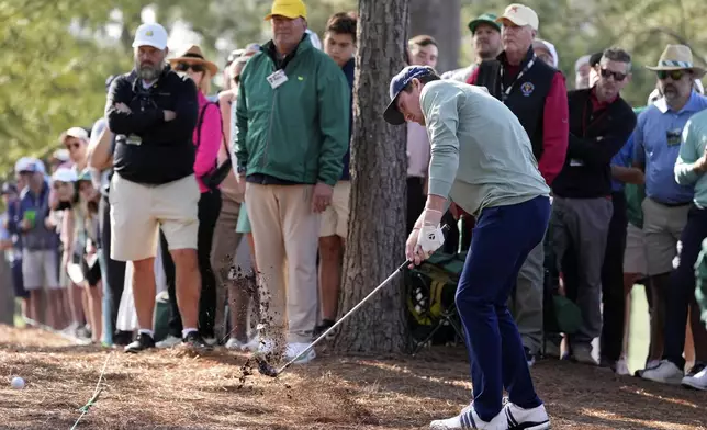 Nick Dunlap hits from the pine straw on the first hole during the first round at the Masters golf tournament, Thursday, April 10, 2025, in Augusta, Ga. (AP Photo/Ashley Landis)