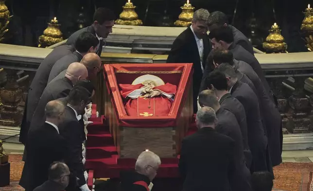 Pallbearers place the body of Pope Francis inside St. Peter's Basilica at the Vatican, Wednesday, April 23, 2025, where he will lie in state for three days. (AP Photo/Andrew Medichini, Pool)