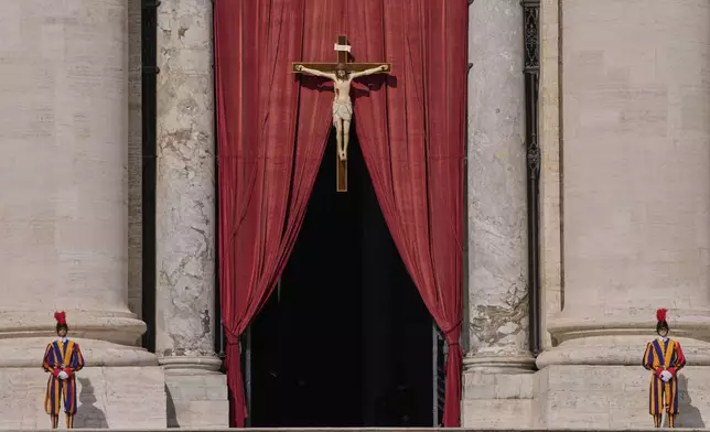 Pontifical Swiss guards stand outside the St. Peter's Basilica, in St. Peter's Square, where the body of Pope Francis will lie in state at for three days, at the Vatican, Wednesday, April 23, 2025. (AP Photo/Bernat Armangue)