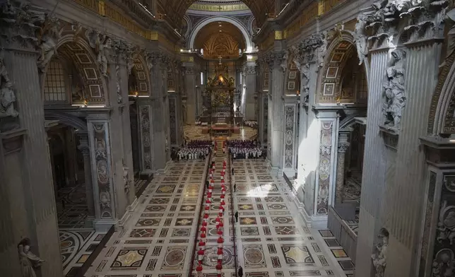 Cardinals lead the procession of transferring the body of Pope Francis into St. Peter's Basilica at the Vatican, Wednesday, April 23, 2025, where he will lie in state for three days. (AP Photo/Andrew Medichini, Pool)