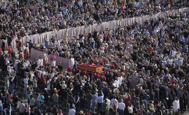 The body of Pope Francis is carried through St. Peter's Square to St. Peter's Basilica at the Vatican, Wednesday, April 23, 2025, where he will lie in state for three days. (AP Photo/Markus Schreiber)