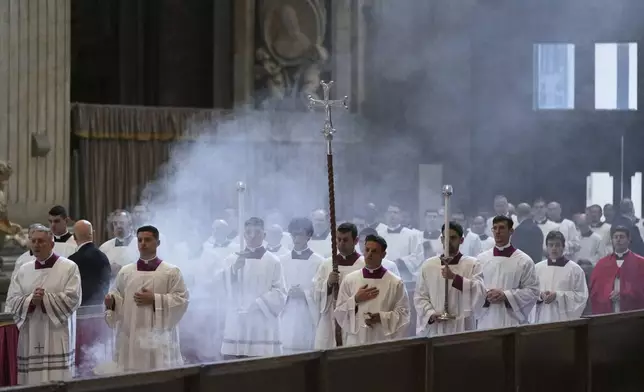 The procession with the body of Pope Francis, who will lie in state for three days, enters St. Peter's Basilica at the Vatican, Wednesday, April 23, 2025. (AP Photo/Francisco Seco)