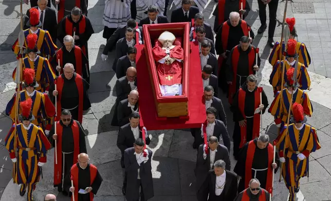 The body of late Pope Francis is carried in an open coffin through St. Peter's Square to St. Peter's Basilica at the Vatican on Wednesday, April 23, 2025, where the deceased pontiff will lie in state for three days. (Vatican Media via AP)