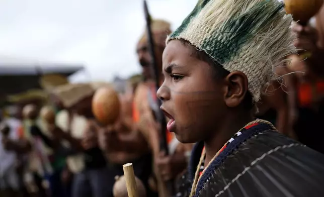 Indigenous people march during the annual Free Earth camp, where they discuss rights, territorial protection and their role in COP30 which will take place for the first time in the Amazon, in Brasilia, Brazil, Tuesday, April 8, 2025. (AP Photo/Eraldo Peres)