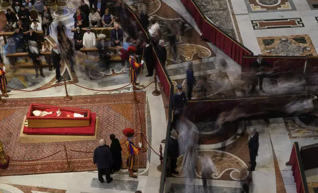 People pay their respect to the late Pope Francis who will lie in state inside St. Peter's Basilica until Friday, at the Vatican, Thursday April 24, 2025. (AP Photo/Gregorio Borgia)