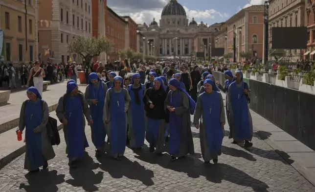 Nuns walk away from St. Peter's Basilica where Pope Francis is lying in state, at the Vatican, Friday, April 25, 2025. (AP Photo/Francisco Seco)