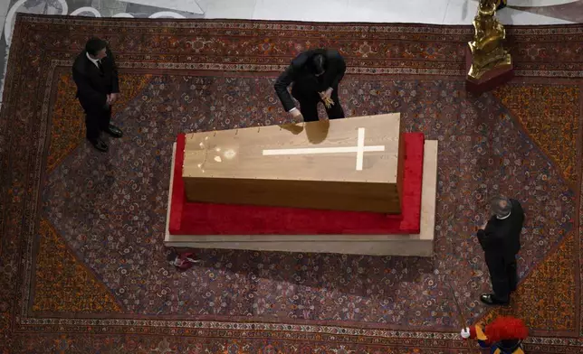 Cerimonial ushers close the casket containing the body of Pope Francis in St. Peter's Basilica at the Vatican Friday, April 25, 2025. (Vatican Media via AP)