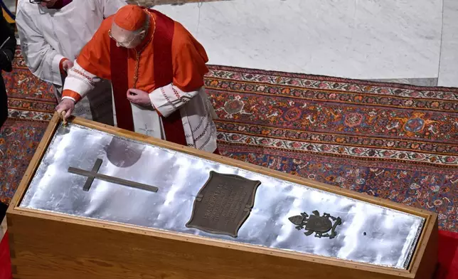 Cardianal Camerlengo Kevin Joseph Farrel seals the zinc cover of the casket containing the body of late Pope Francis in St. Peter's Basilica at the Vatican Friday, April 25, 2025. (Vatican Media via AP)