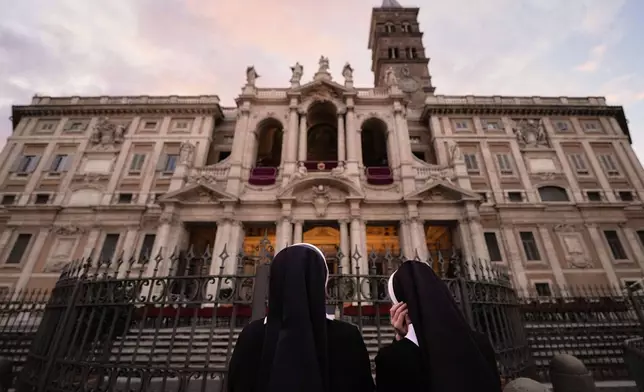 Nuns wait before a rosary prayer outside the Santa Maria Maggiore Basilica, where the late Pope Francis will be buried, in Rome, Thursday, April 24, 2025. (AP Photo/Andreea Alexandru)