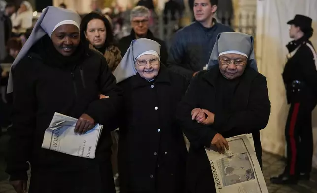 Nuns support each other as they leave after attending a rosary prayer outside the Santa Maria Maggiore Basilica, where the late Pope Francis will be buried, in Rome, Thursday, April 24, 2025. (AP Photo/Andreea Alexandru)